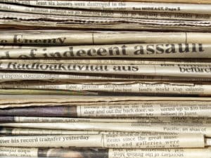 Pile of newspapers with Indecent Assault 