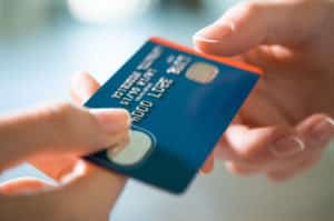 Person handing over credit card 